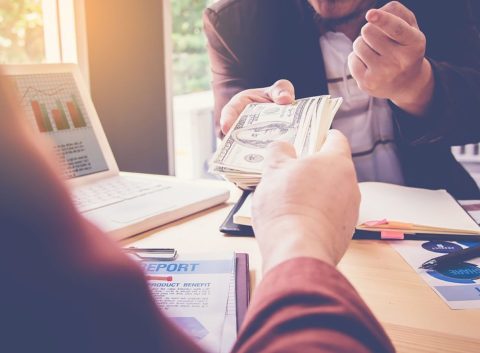person handing over cash