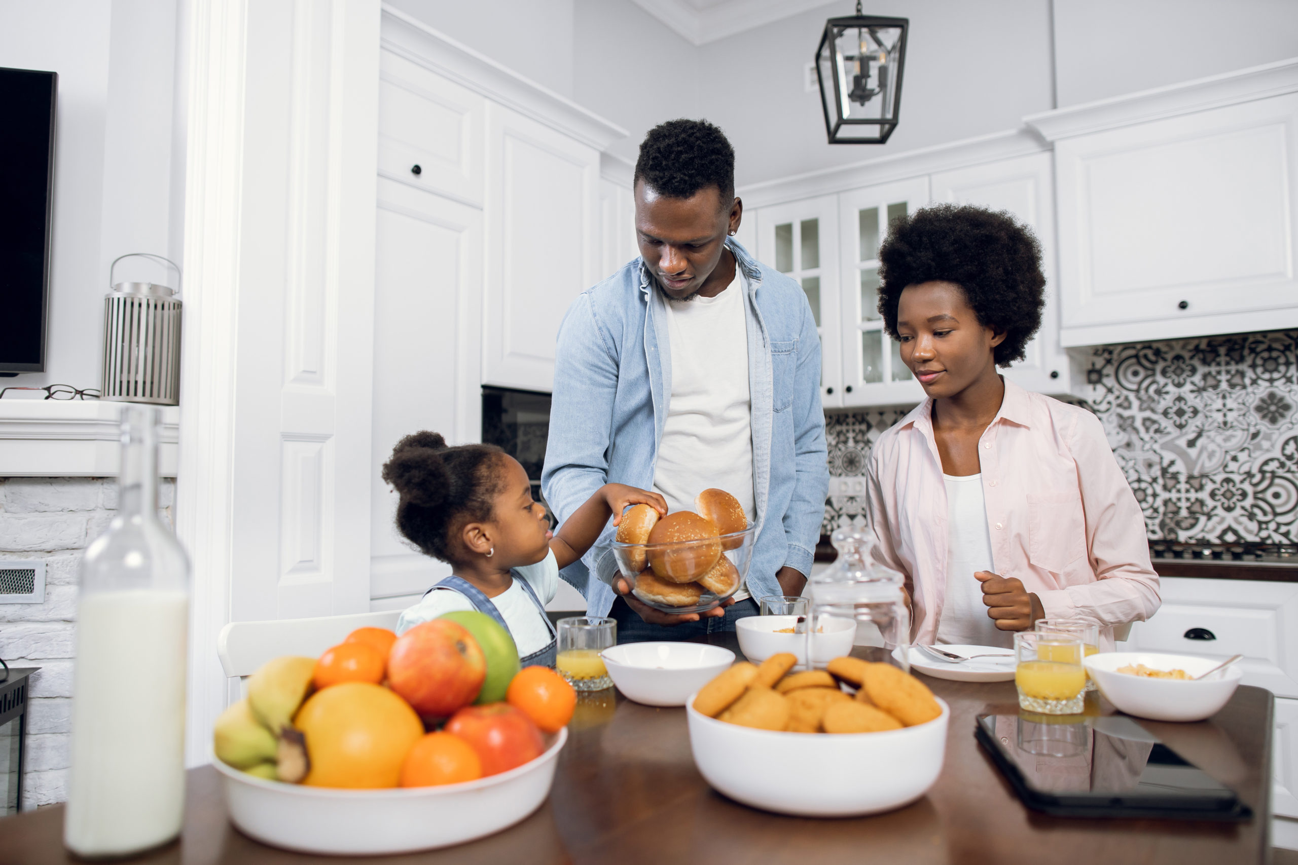 parents with their daughter in the kitchen