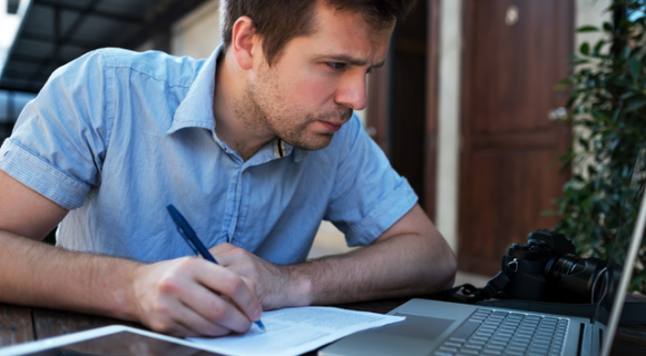 man makes a business plan on his computer