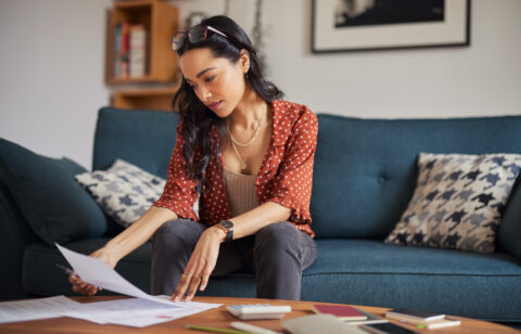 Woman reading bills at home