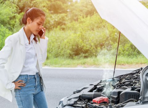 woman stranded on road with car troubles