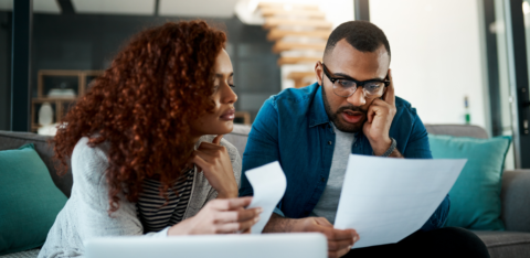 Man looking at bill with wife