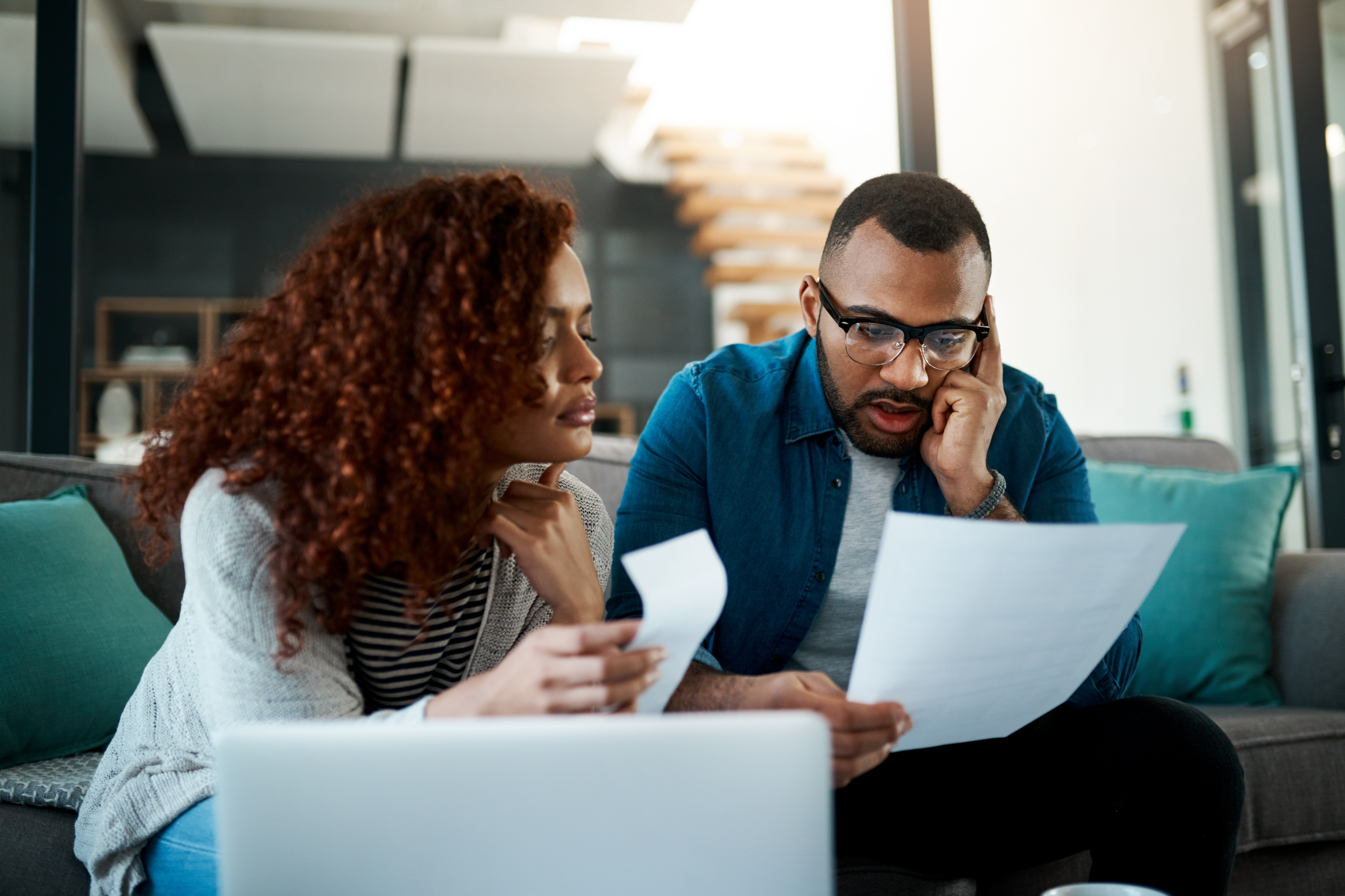 Man looking at bill with wife