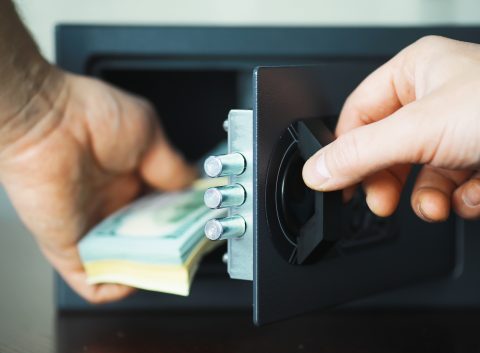 putting money away in a safe