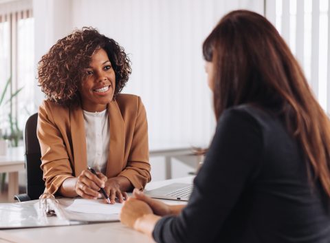 Financial advisor having a friendly consultation with a client in a bright office setting.