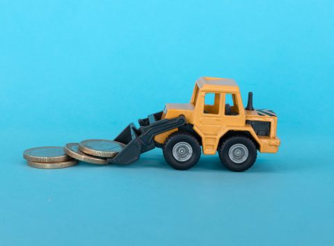 Miniature construction vehicle moving coins